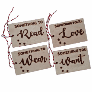 Luxury hand burnt wooden christmas gift tags saying 'something to wear,, something you want, something to read or something you'll love'