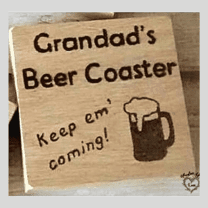 Solid oak coaster featuring a rustic design, perfect for grandad's beer. The coaster is made from high-quality oak wood, providing a sturdy and durable surface to protect surfaces from condensation and heat. Its natural grain and rich color add a touch of elegance to any table setting. The coaster is shaped in a classic square form with smooth edges, making it easy to handle and clean. It proudly displays the words 'Grandad's Beer' in bold, engraved lettering, making it a thoughtful and personalized gift for any grandfather who enjoys a cold brew."