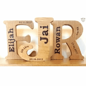 A solid oak freestanding letter personalized with new baby details. The letter, crafted from high-quality oak wood, stands upright on a flat surface. It is beautifully engraved with the name, birth date, and other unique details of the newborn. The natural grain of the oak wood adds warmth and character to the piece, while the personalized details make it a cherished keepsake. This freestanding letter serves as a thoughtful and personalized gift to celebrate the arrival of a new baby