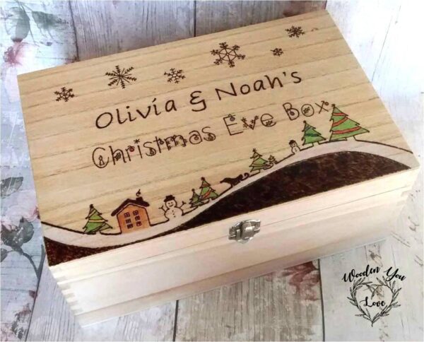 handmade wooden christmas eve box. Hand burnt festive design of a house, snowman and christmas tree. Personalised with names.