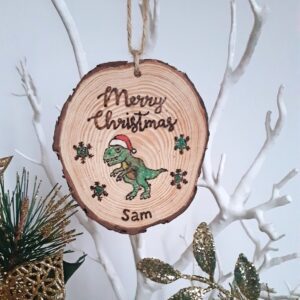 This handmade wooden christmas ornament is perfect for a dinosaur lover. Personalised with a name and with a touch of sparkle.