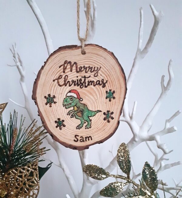 This handmade wooden christmas ornament is perfect for a dinosaur lover. Personalised with a name and with a touch of sparkle.