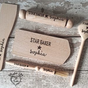 An image of a hand-burnt mini baking set for kids. The set includes a small wooden rolling pin, pastry brush, spatula, spoon and board. This delightful mini baking set is perfect for young aspiring bakers to explore their creativity and enjoy baking adventures."
