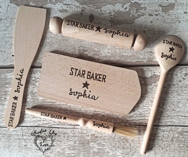 An image of a hand-burnt mini baking set for kids. The set includes a small wooden rolling pin, pastry brush, spatula, spoon and board. This delightful mini baking set is perfect for young aspiring bakers to explore their creativity and enjoy baking adventures."
