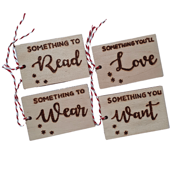 Luxury hand burnt wooden christmas gift tags saying 'something to wear,, something you want, something to read or something you'll love'