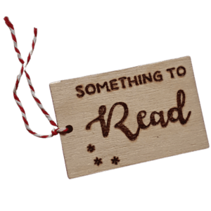 Luxury hand burnt wooden christmas gift tags saying 'something to read'