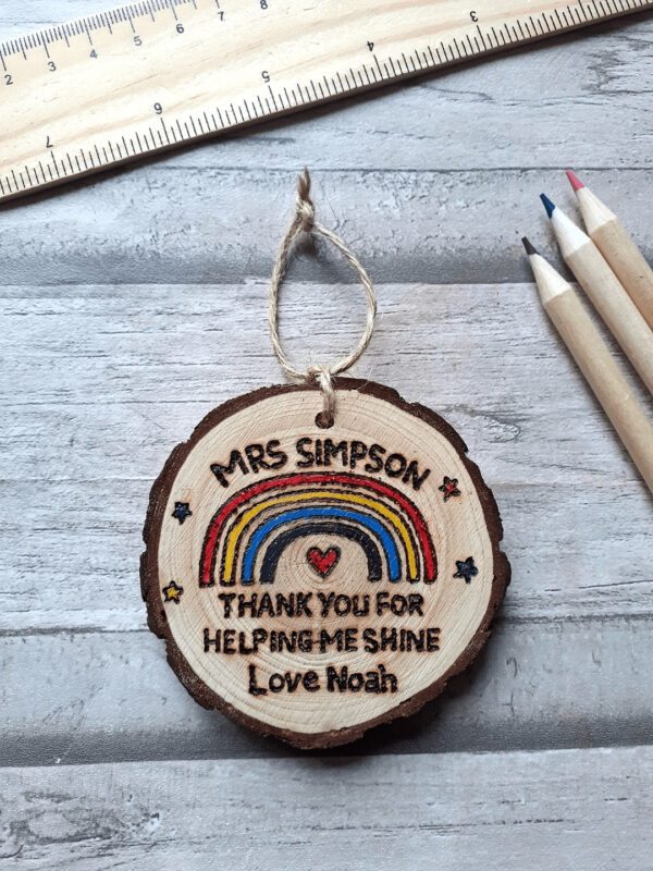 Handmade wooden personalised rainbow decoration. Features a rainbow and personalised with a teachers name and who it is from. Says Thank you for helping me shine.