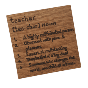 A square handmade wooden coaster made of oak, describing a teacher. The coaster features a hand-burnt inscription in a charming, rustic font. The wood's natural grain and texture are visible, adding to its artisanal and heartfelt appearance.