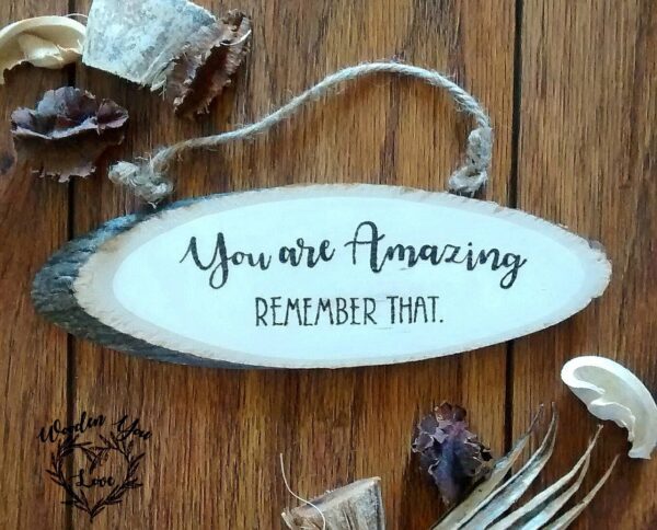 Hand burnt rustic log plaque which reads, 'you are amazing, remember that'.