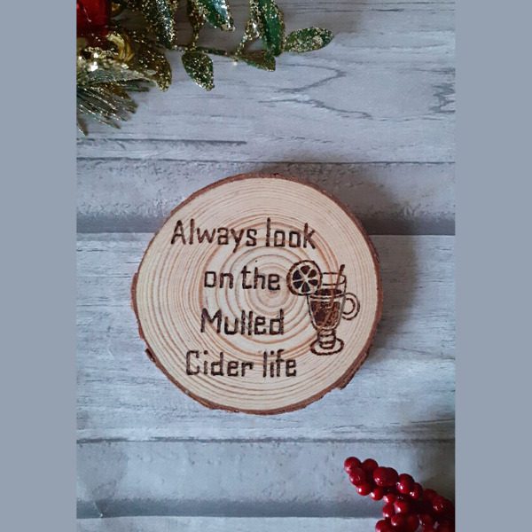 handmade wood slice mulled cider christmas coaster. Reads 'always look on the mulled cider life' with a mulled cider hand burned drawing