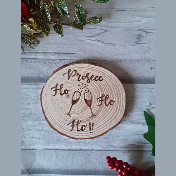 handmade wood slice christmas prosecco coaster. Says 'prosecc ho ho ho' with prosecco glasses design
