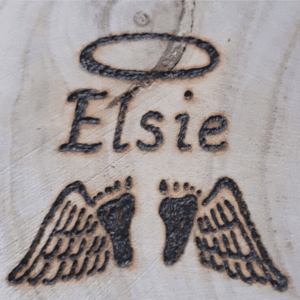 hand burnt image of baby feet with angel wings and with a personalised name