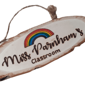 handmade wooden personalised log plaque with hand burnt teacher name and a colourful rainbow