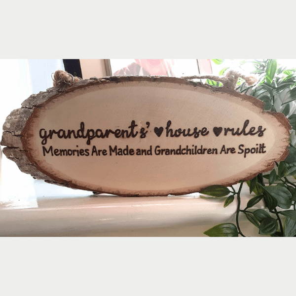 Wooden hanging sign with text: 'Grandparents House Rules: Where Memories Are Made and Grandchildren Are Spoiled.'"