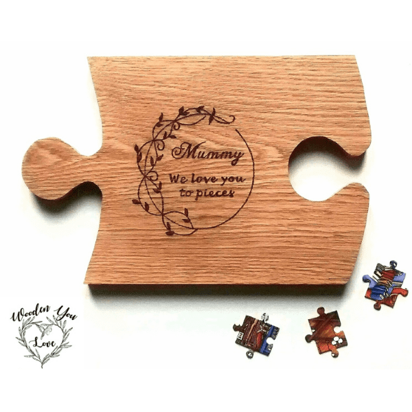 A close-up image of an oak cheese board in the shape of a jigsaw puzzle piece. The board is made of polished oak wood, with a smooth surface and a warm, rich color. The edges of the puzzle piece are intricately carved to resemble the interlocking pattern of a jigsaw puzzle. The board features a spacious area for arranging various types of cheeses, crackers, and fruits. It is an elegant and unique cheese board that adds a touch of whimsy to any table setting."