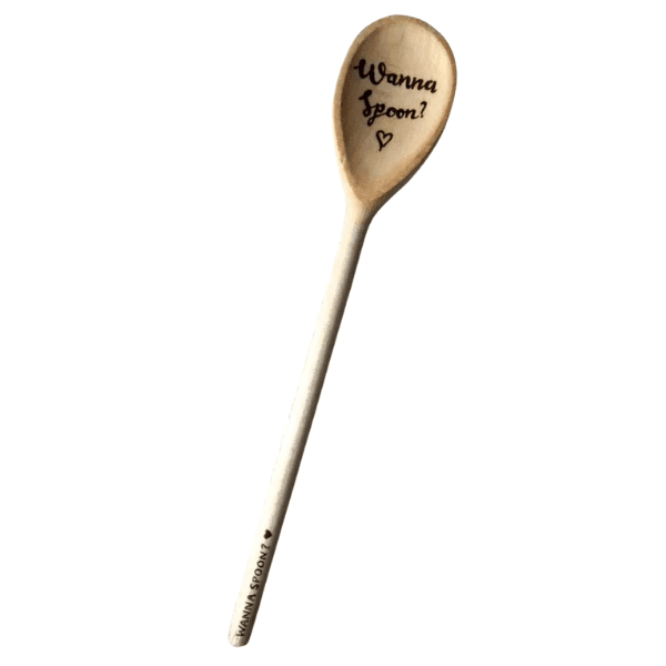 A wooden spoon which is engraved with the playful text "wanna spoon."